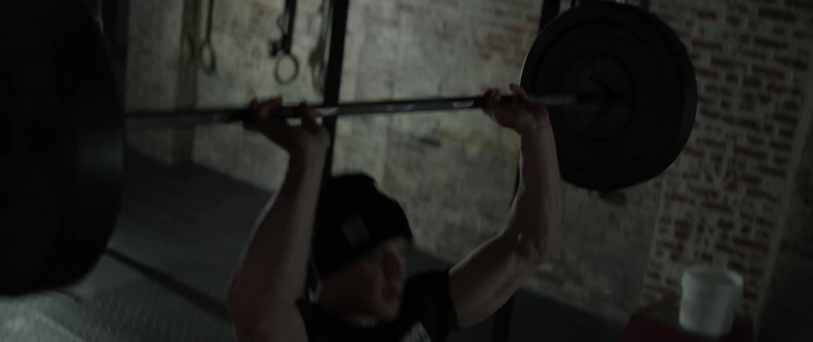 A man lifts a barbell