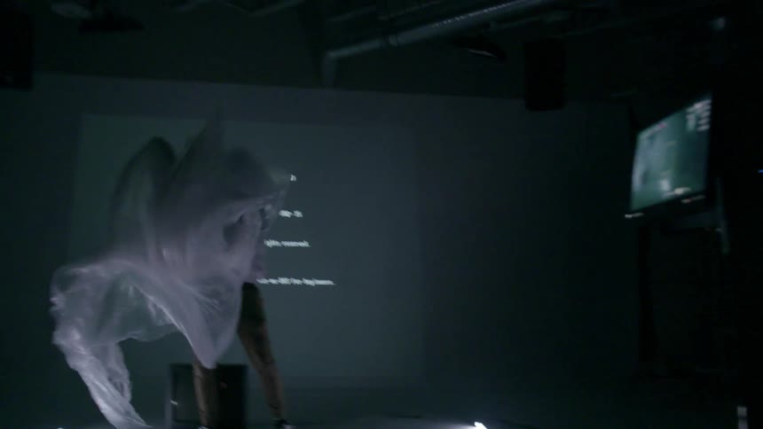 A man flails in a white cloth