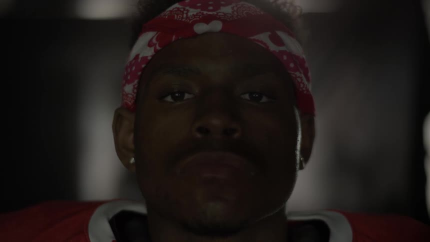 A football player stands in a tunnel
