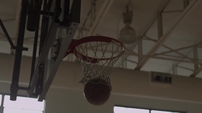 A basketball swishes through a basketball hoop