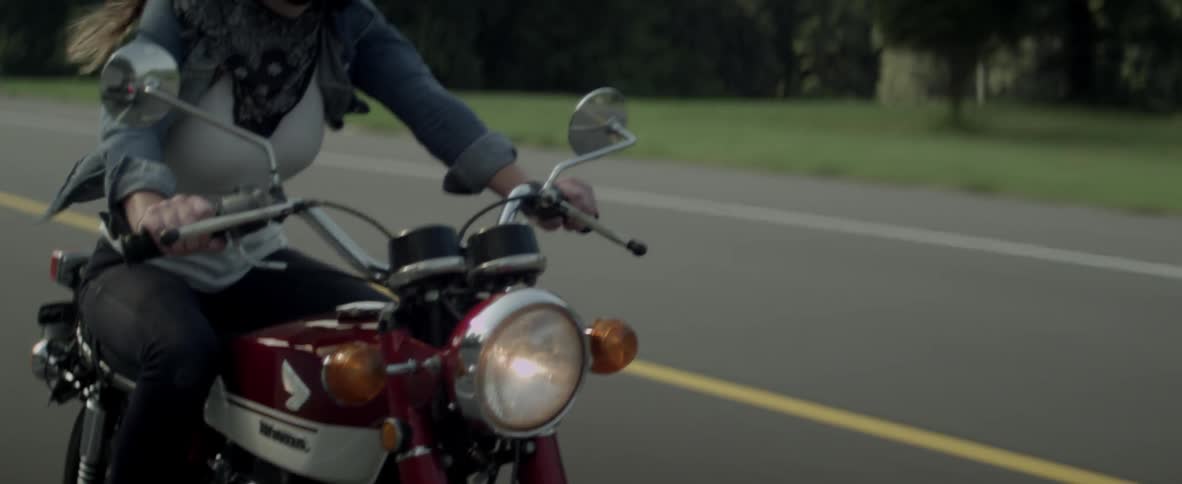 A woman rides a motorcycle