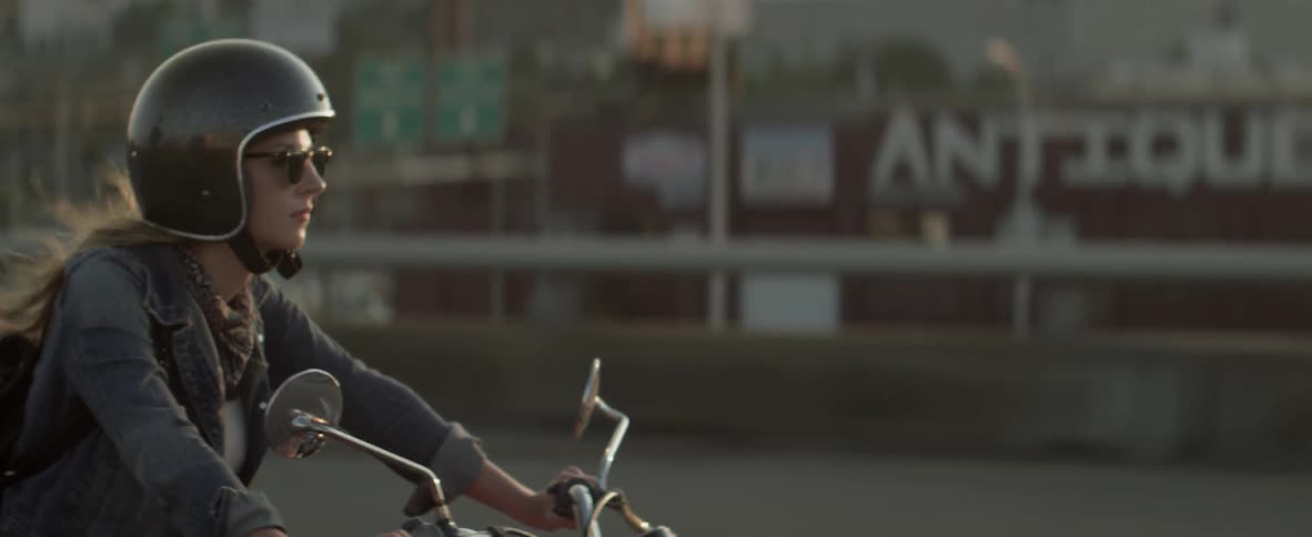A woman rides a motorcycle