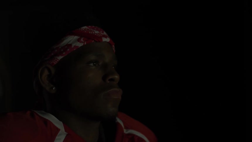 A football player stares straight ahead as he walks