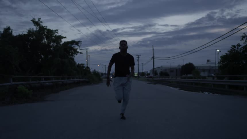 A young man runs out in the street