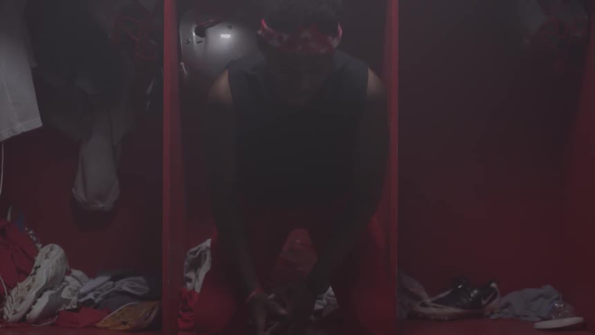 A man sits in a locker room