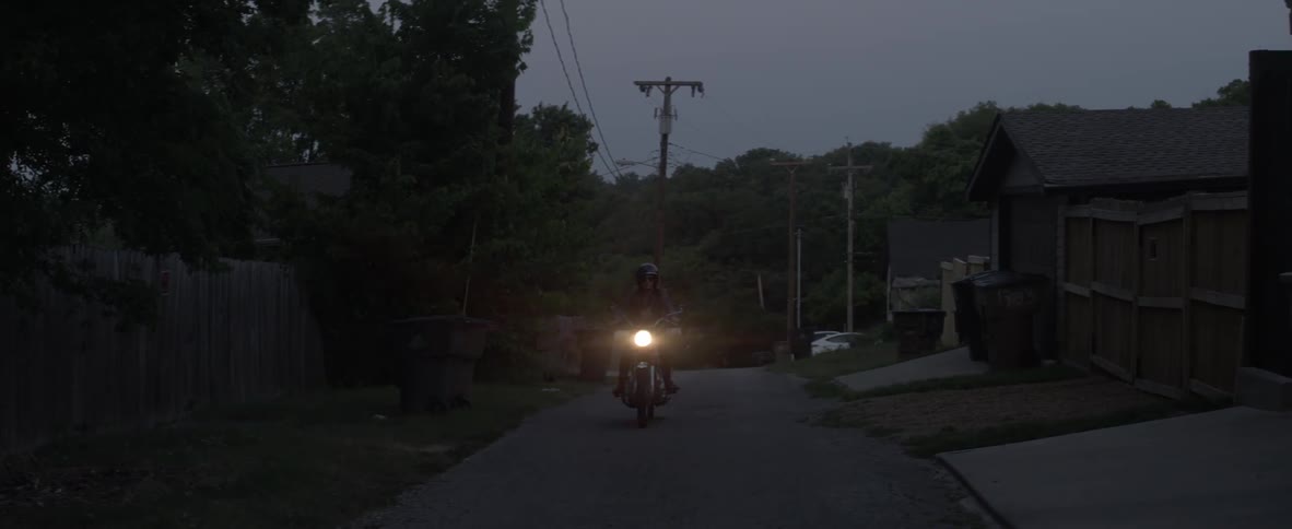 Woman on a motorcycle travels down the road