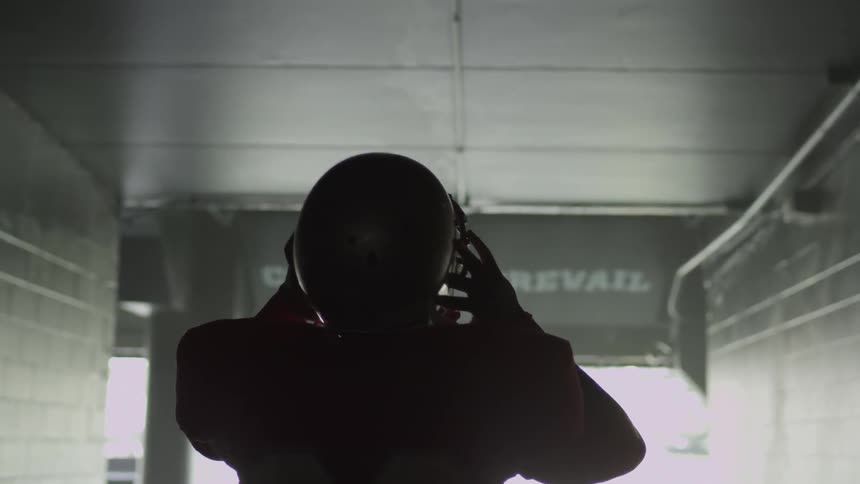 A football walks towards the end of a tunnel