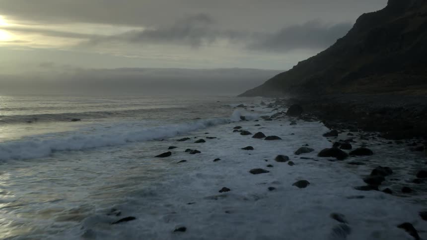 Waves flow onto the rocky shore