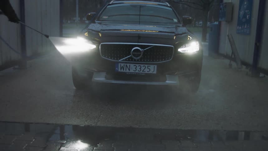 A person washes their car
