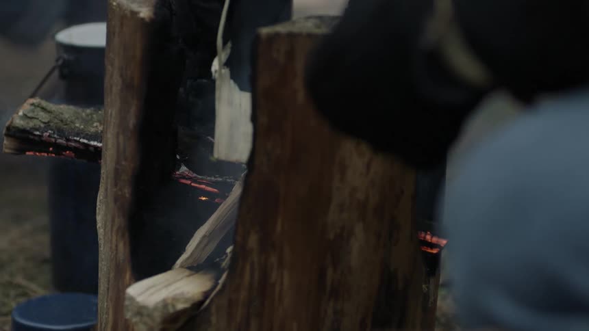 Smoking log at a piece of paper being dropped between it