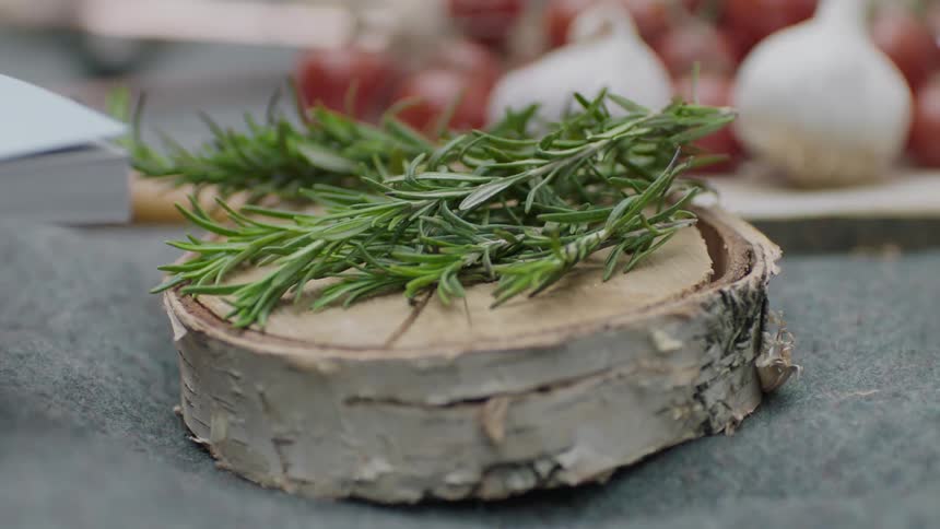 Sprigs of herbs on a piece of wood