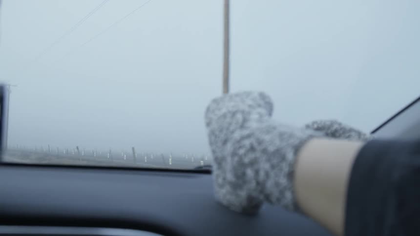 A woman has her feet on the dash in a car