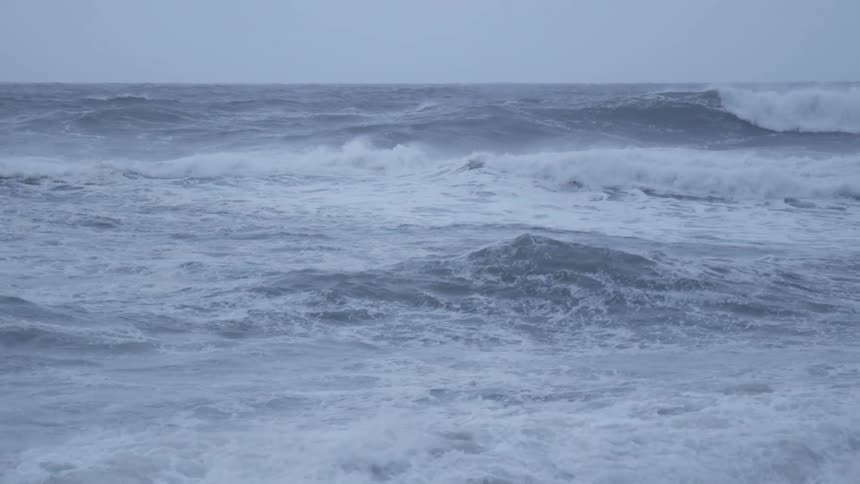 Storm waves are crashing and rolling in the ocean
