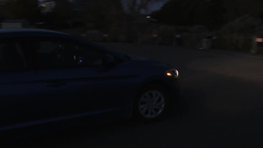 A vehicle turns to the left at night