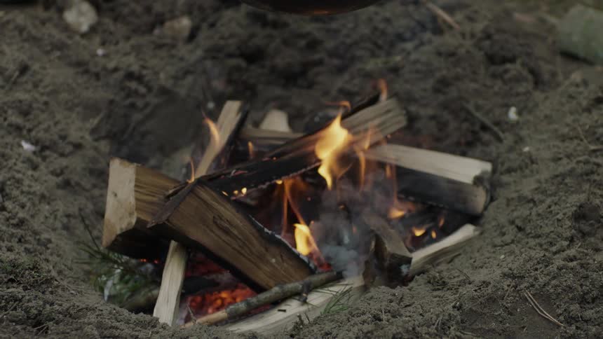 A small fire pit with a fire in it