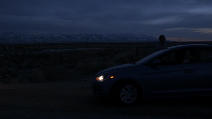 Man approaches a vehicle in the dark and gets inside