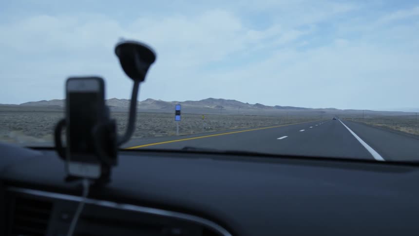 Vehicles drive on a desert road