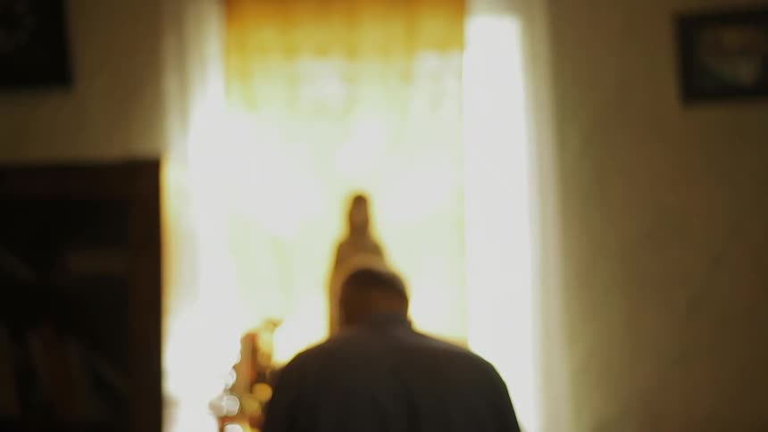 A person sitting before a religious shrine in a room