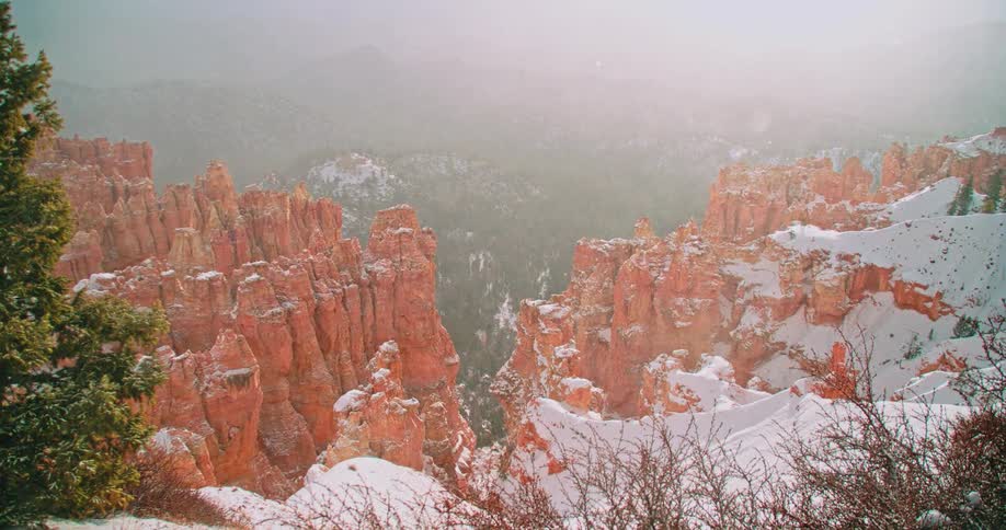 Snow drifts off of the mountain top