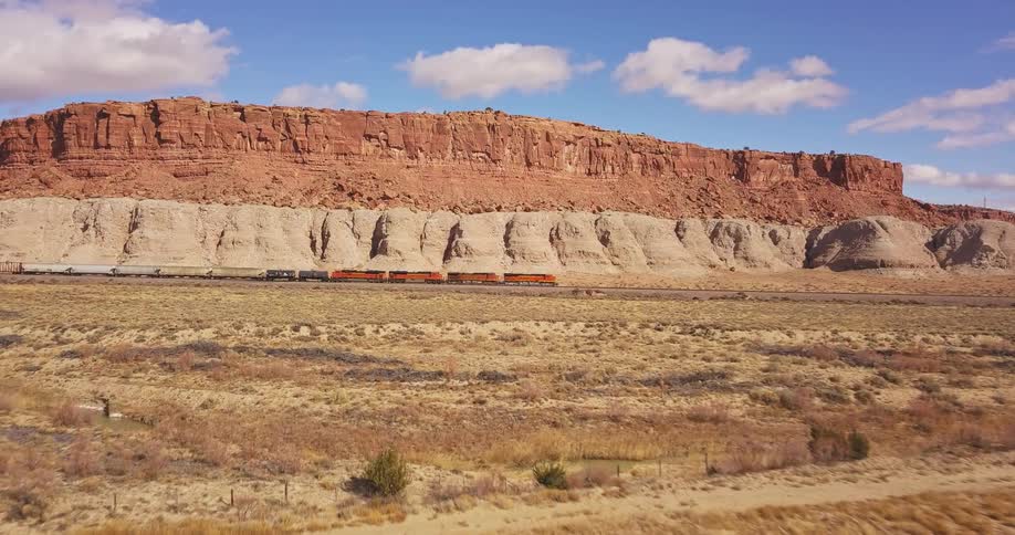 Mountains sit near the desert under a blue sky