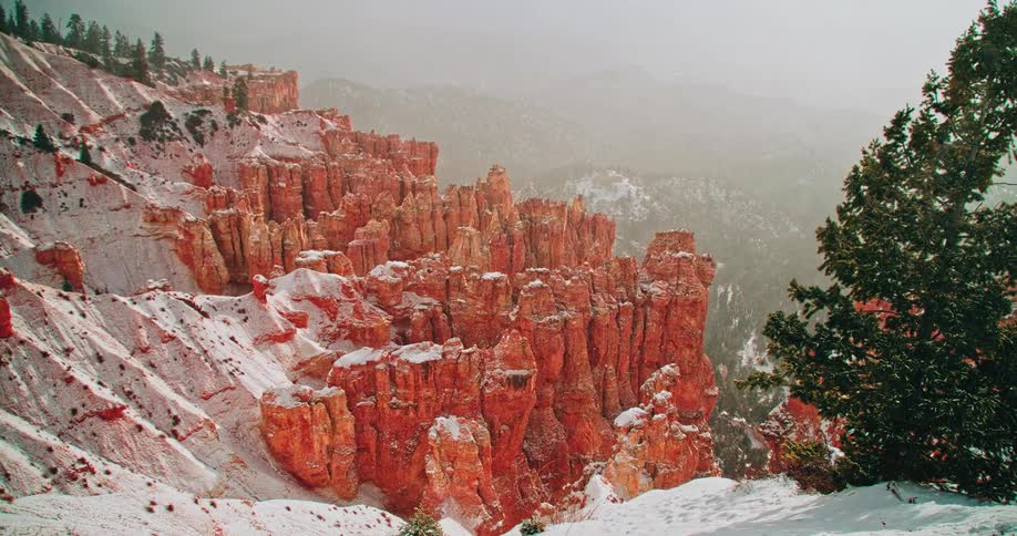 Snow drifts off of the mountain top
