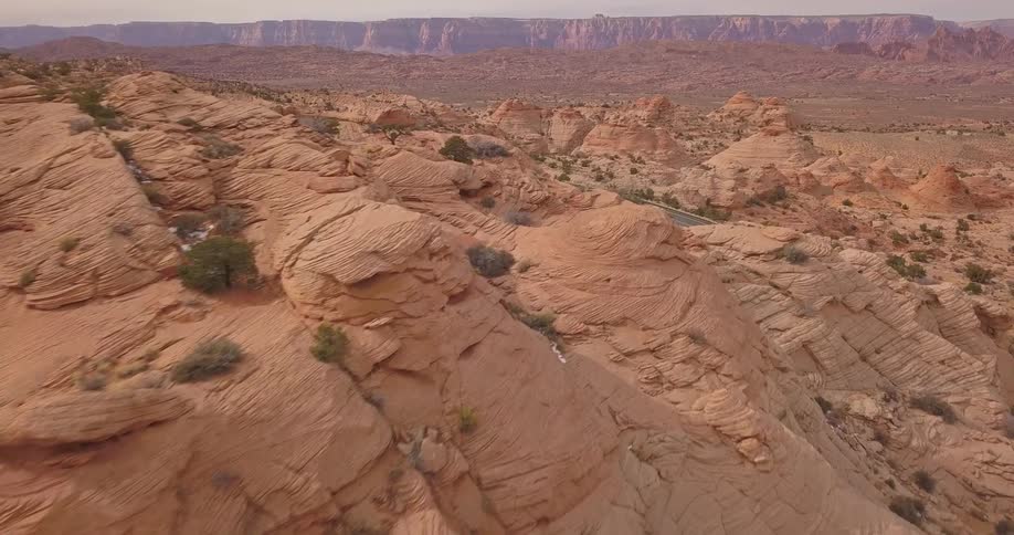 A vehicle drives through a rocky desert