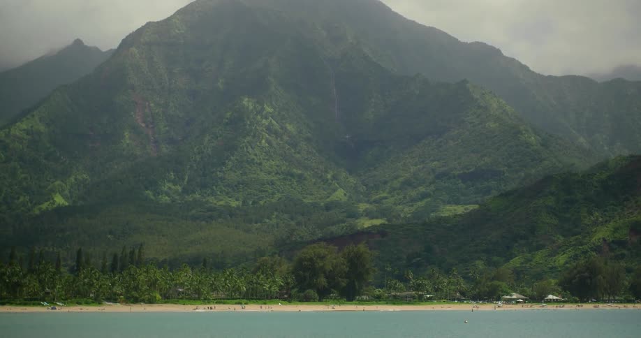 Hazy clouds hang above a mountain and lake