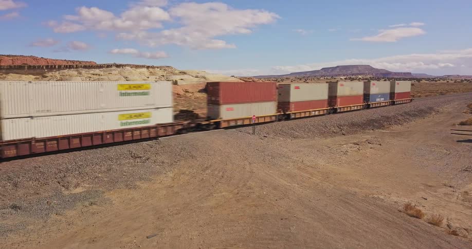 A train carrying cargo travels on the tracks