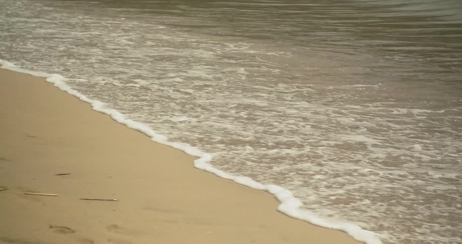 The tide flows and recedes on to the sand