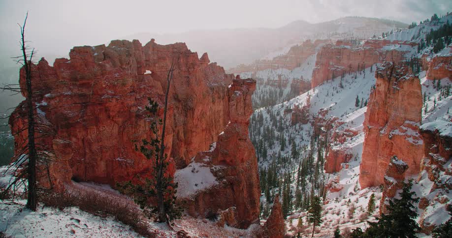 Snow drifts off of the mountain top