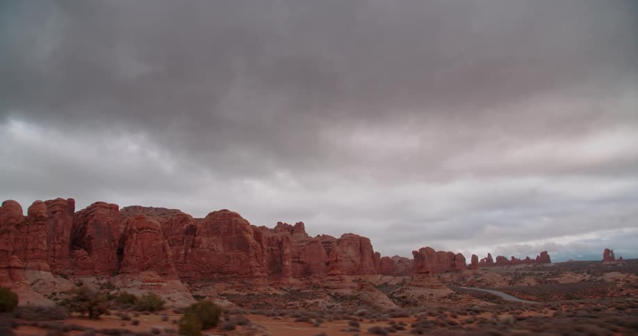 Clouds hang over desert cliffs