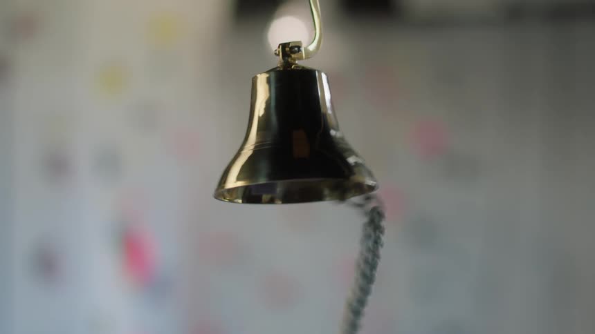 A hanging bell is being rung
