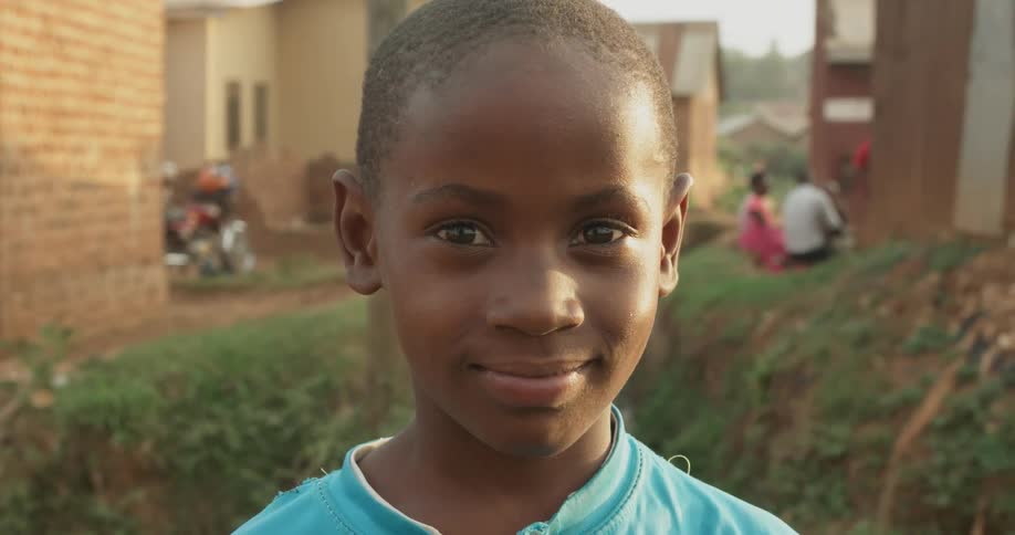 Boy smiles outside on a sunny day