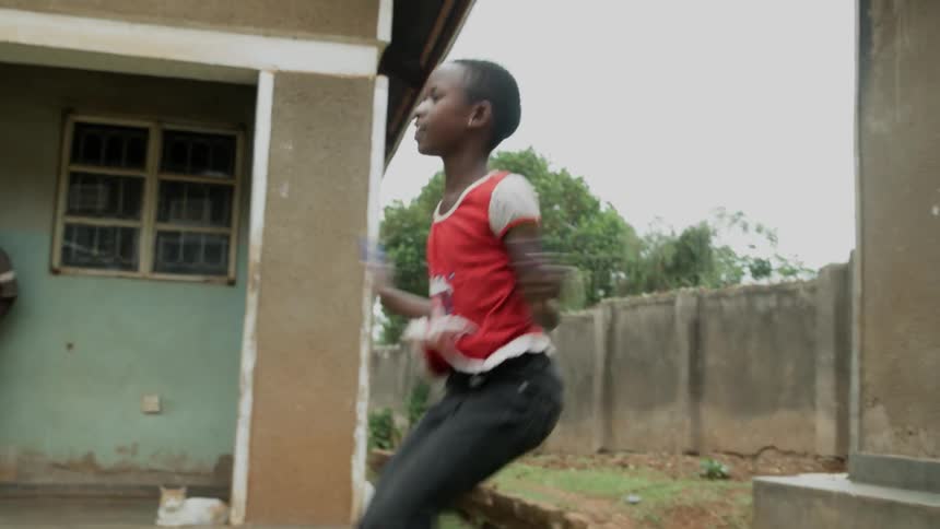A young girl jumps rope outside