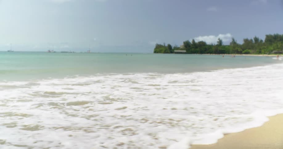 Waves flow onto the beach shore