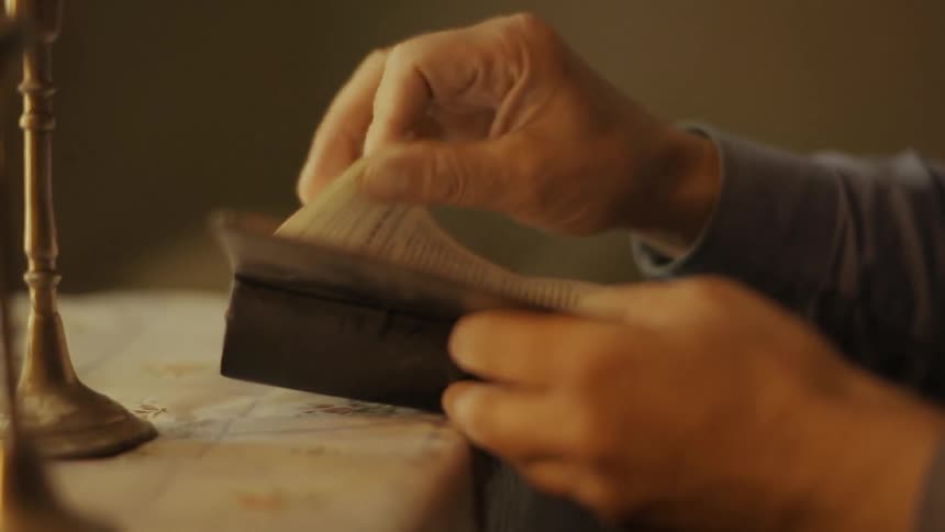 A man sits down to read a religious text