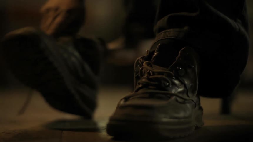 A man puts on his boots