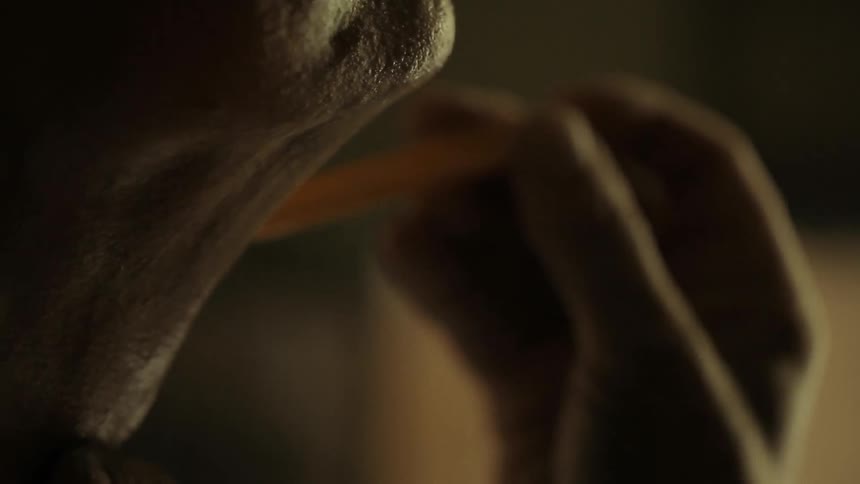 A man shaves his neck