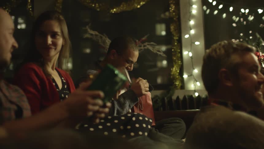 A group of people exchange christmas gifts