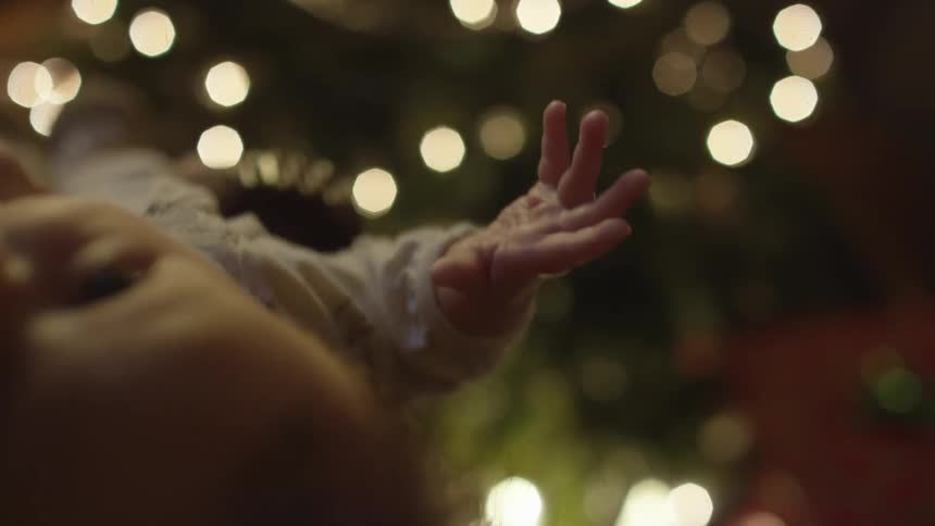 A baby is being carried at a party