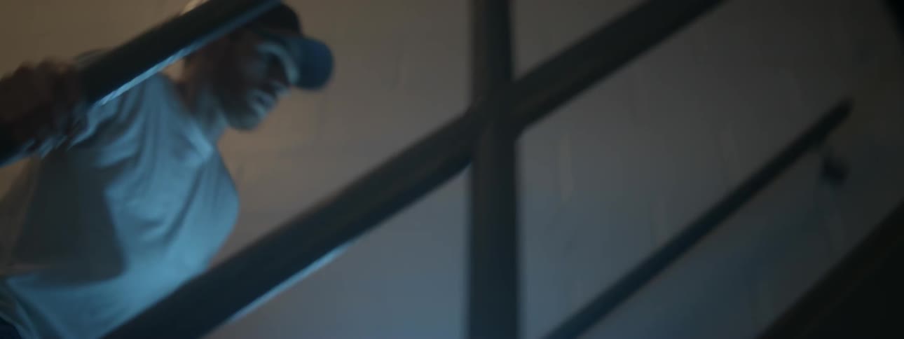 Man carries flashlight and runs up building stairs