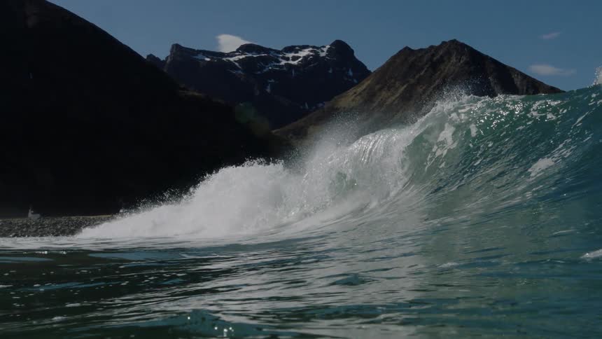 An ocean wave crashes down