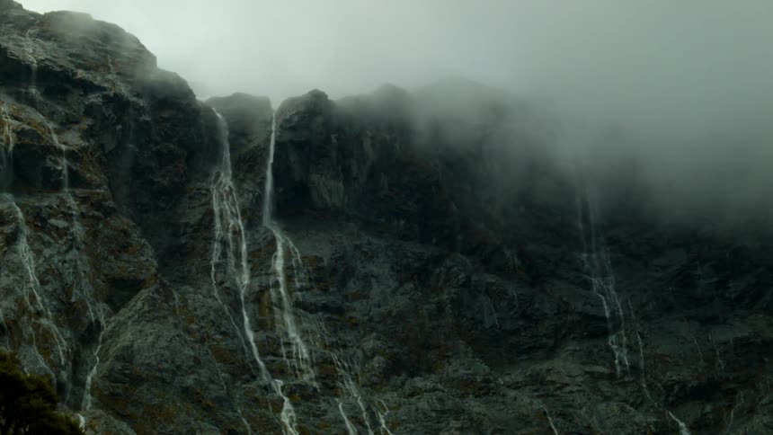 Water flows down the tall cliff