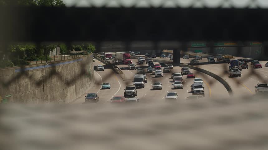 Many vehicles driving down a highway