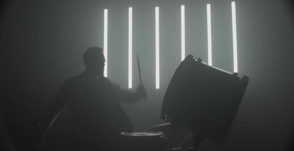 A drummer plays the drums violently