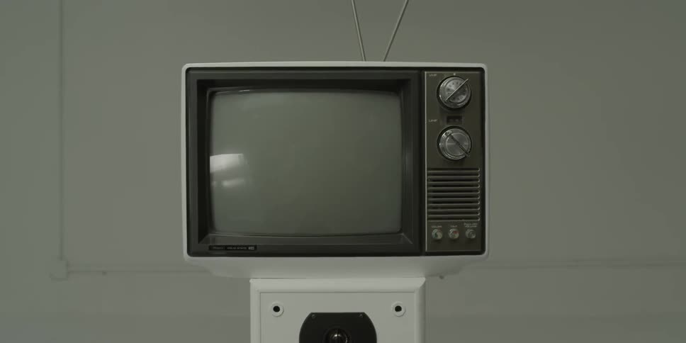 An old television monitor is stacked on top of speakers