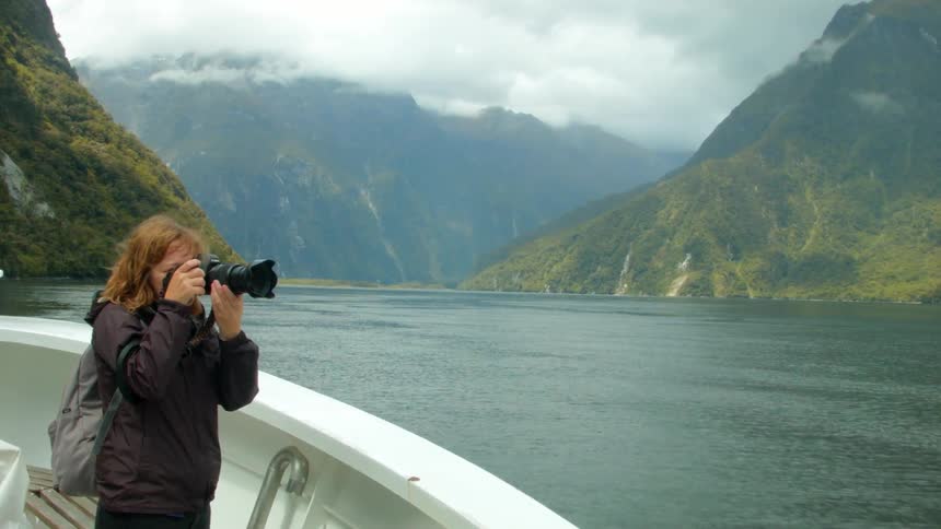 A photographer talks a photo from a boat