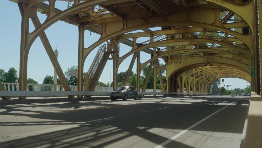 Cars drive over a bridge