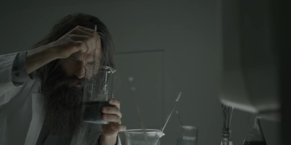 A scientist is mixing a solution in a beaker