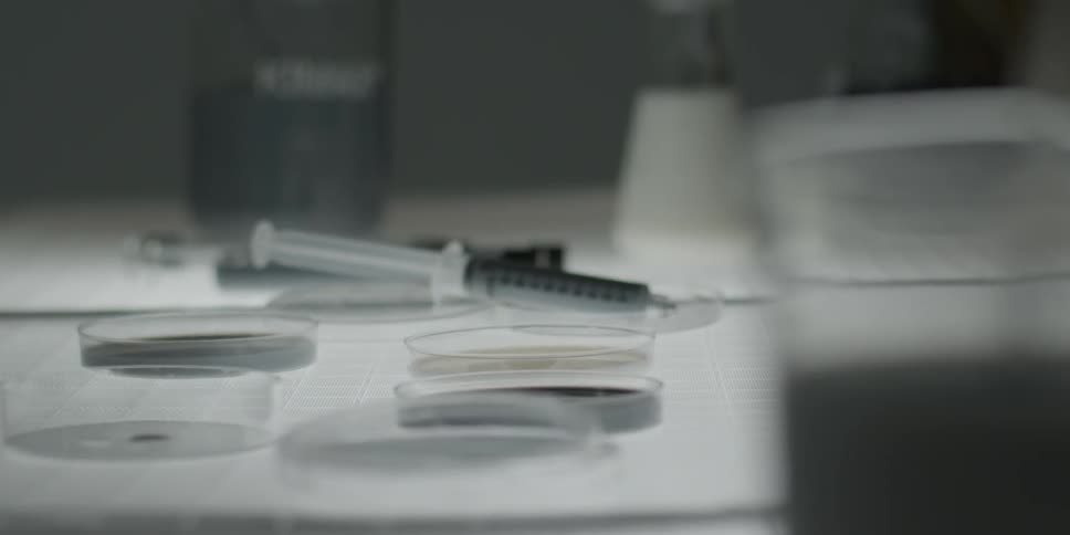 Various lab implements lie idle on a table